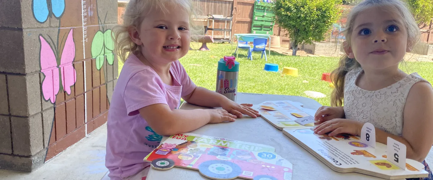 Emma_and_Isla_reading_outside